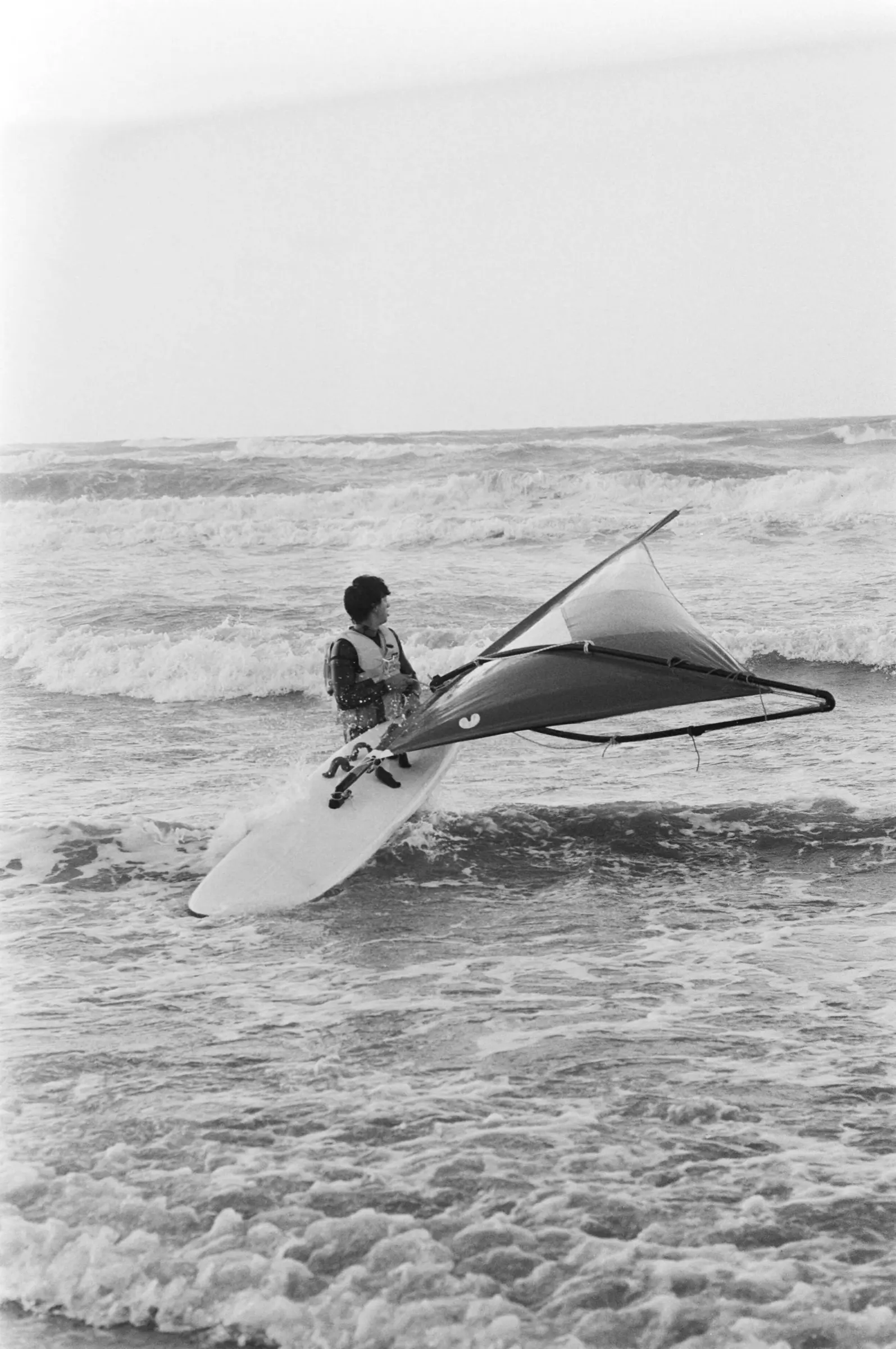 A windsurfer on rough grey sea near Scheveningen