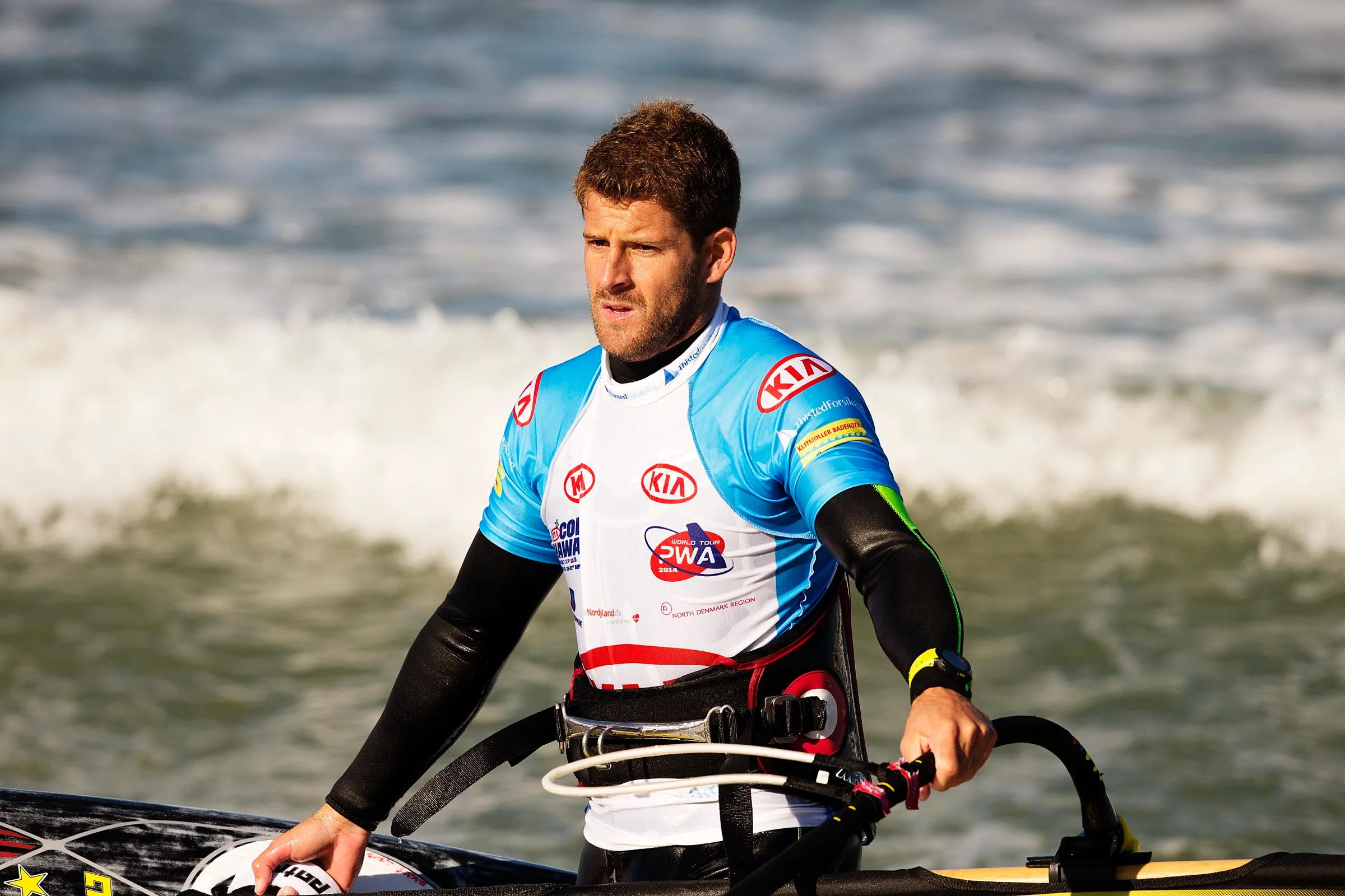 Ricardo Campello on the beach with his board and sail